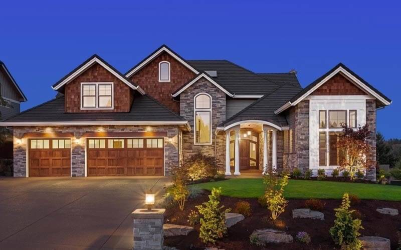 Apex, NC Home for Sale at Dusk with Lighting and Stone Facade
